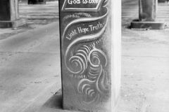 0001-E207B Lovejoy Columns, Portland, Oregon. Paintings on the pillars of the old Lovejoy Ramp created by Greek Immigrant and Artist Tom Stefopoulos from 1948 to 1952. Larry Smith made these photos to propose a newspaper article titled "God Is Love" named after one of the paintings, May 1954.